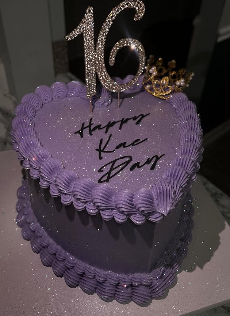 Purple heart-shaped 16th birthday cake with silver number topper and gold tiara