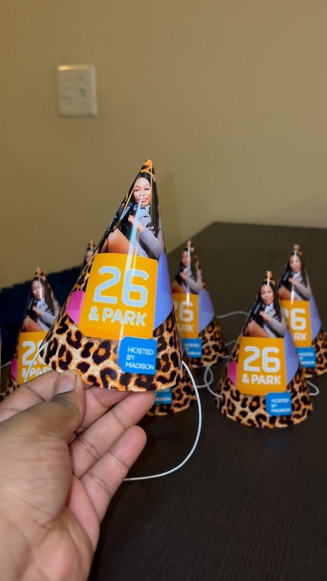 Leopard print party hats with a woman's photo and 26 & Park text.