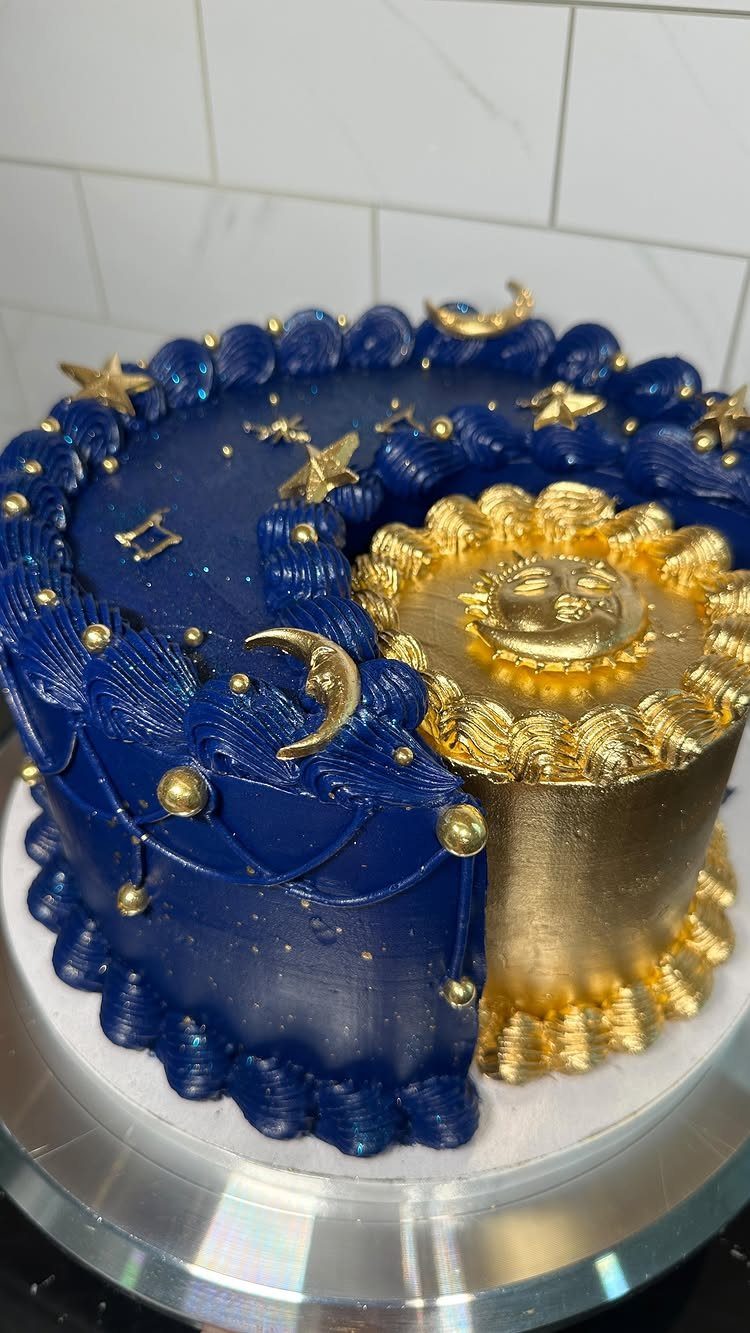 Celestial cake with deep blue night sky and gold sun decorations on silver stand