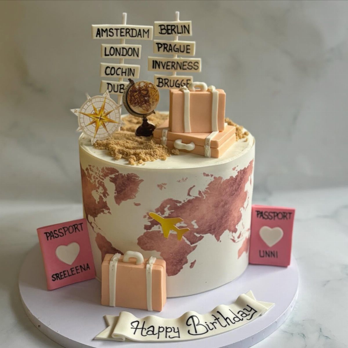 Travel themed birthday cake with world map, suitcases, globe, and city signposts.