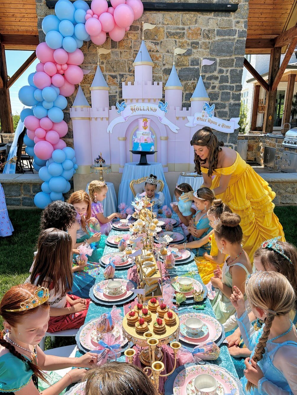 Girls in princess dresses at a tea party with a castle backdrop