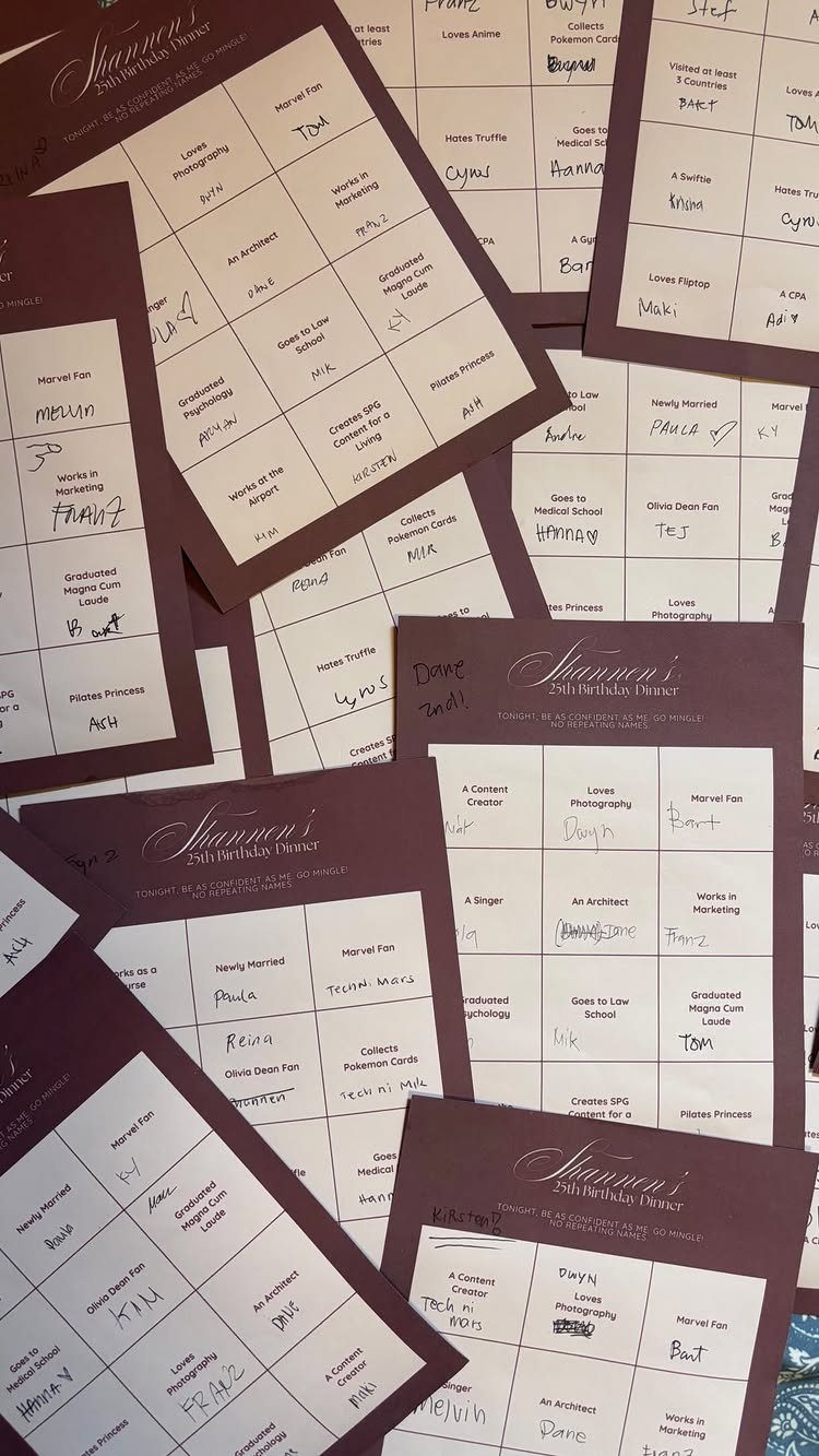 Customized birthday bingo cards with maroon headers and handwritten entries in the grids.