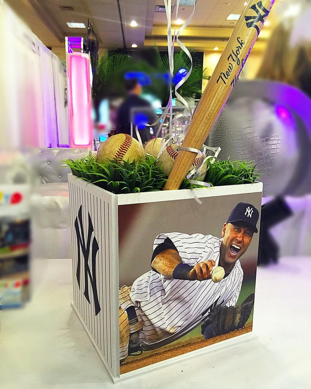Baseball themed centerpiece with a bat, baseballs, and New York Yankees graphics.