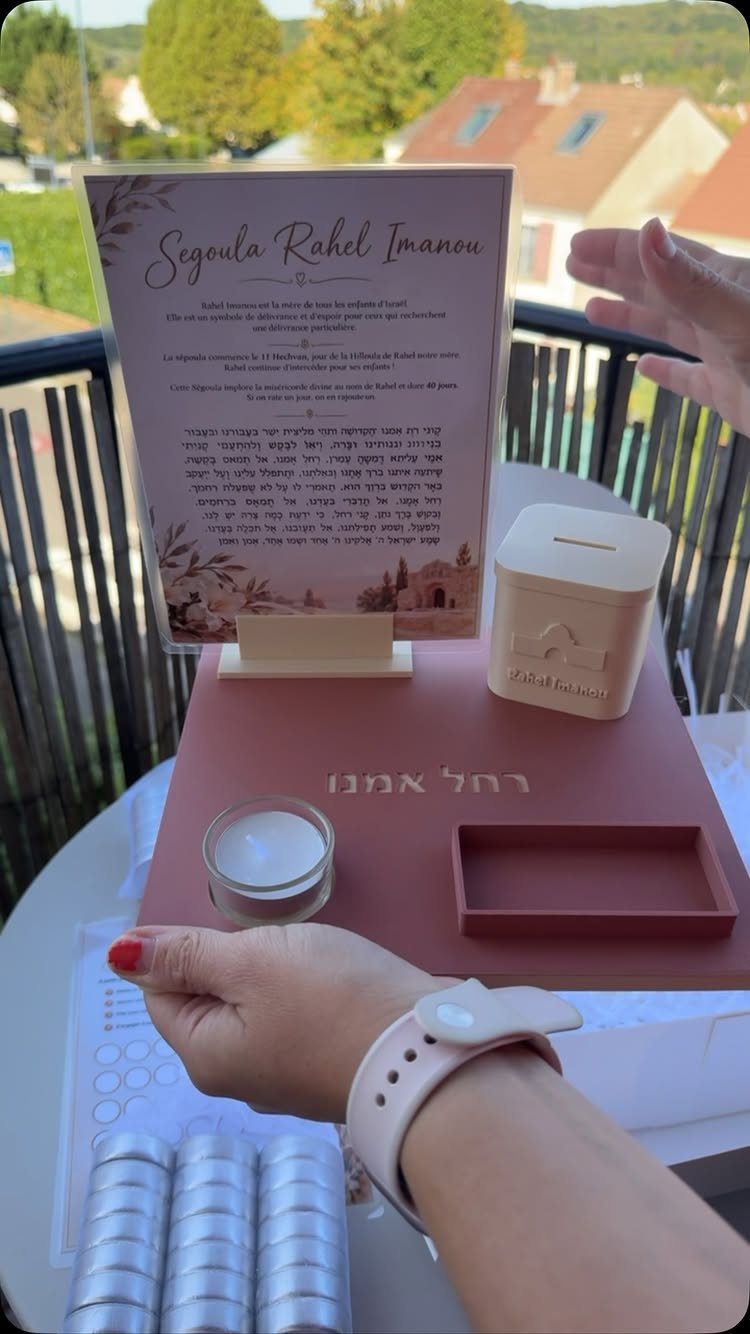 Dusty rose gift tray with a wooden coin bank and framed Hebrew document.