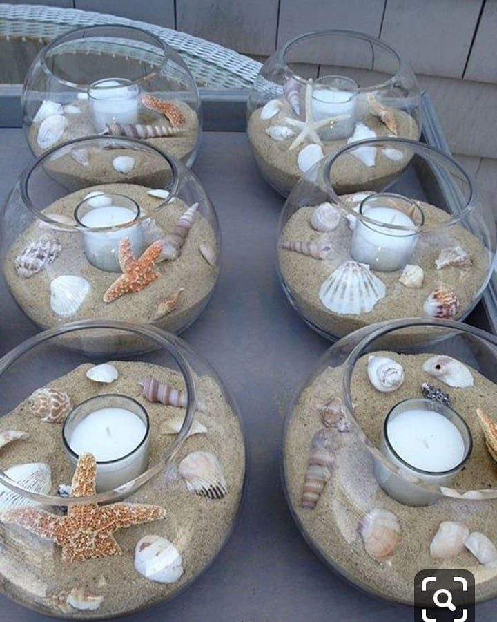Glass bowls with sand, seashells, and tea light candles for beach party decor