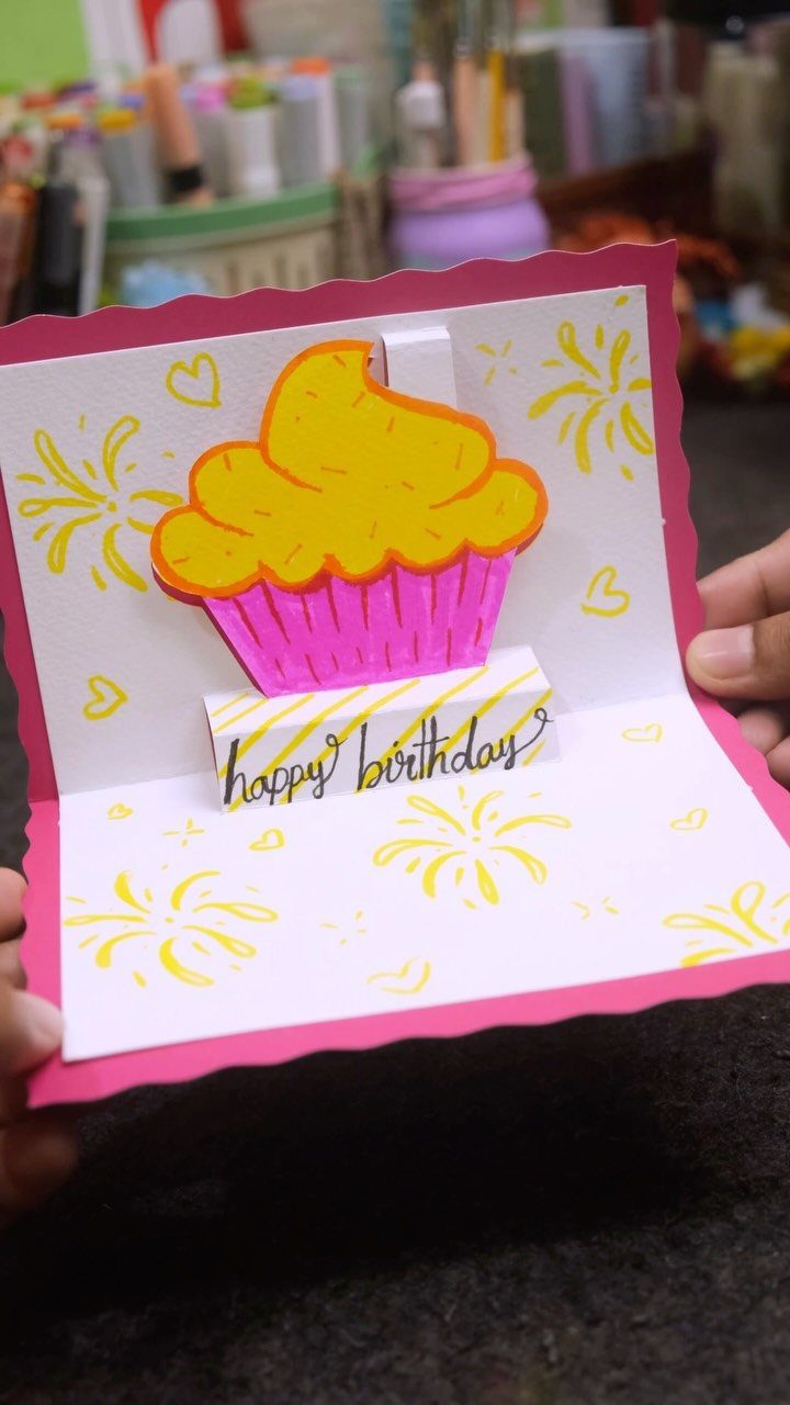 Handmade pop-up birthday card featuring a yellow and pink cupcake doodle and calligraphy.