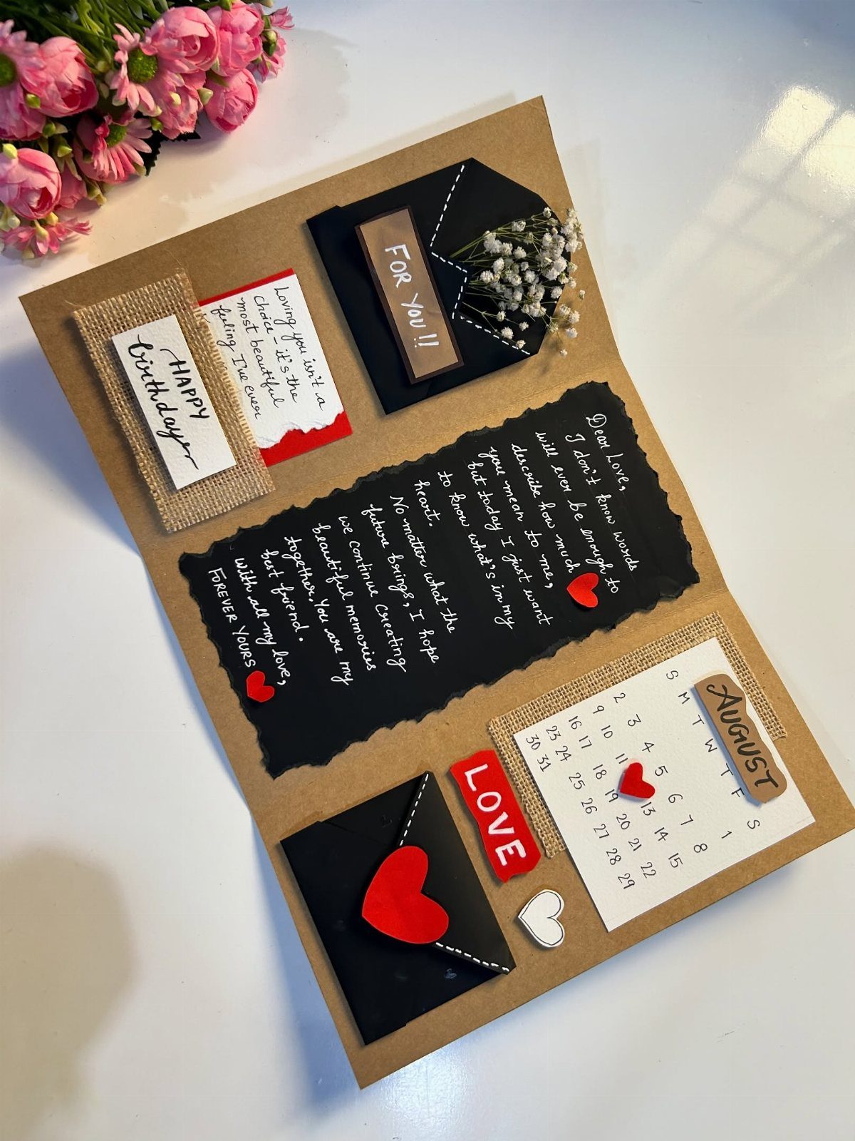 Handmade brown birthday card with a handwritten letter, calendar, and small envelopes.