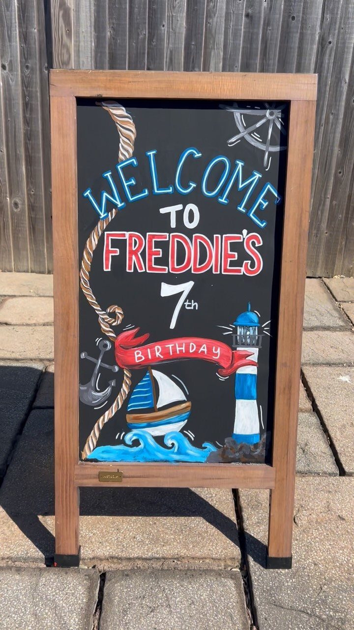 Nautical themed chalkboard birthday sign welcoming guests to Freddie's 7th birthday party.
