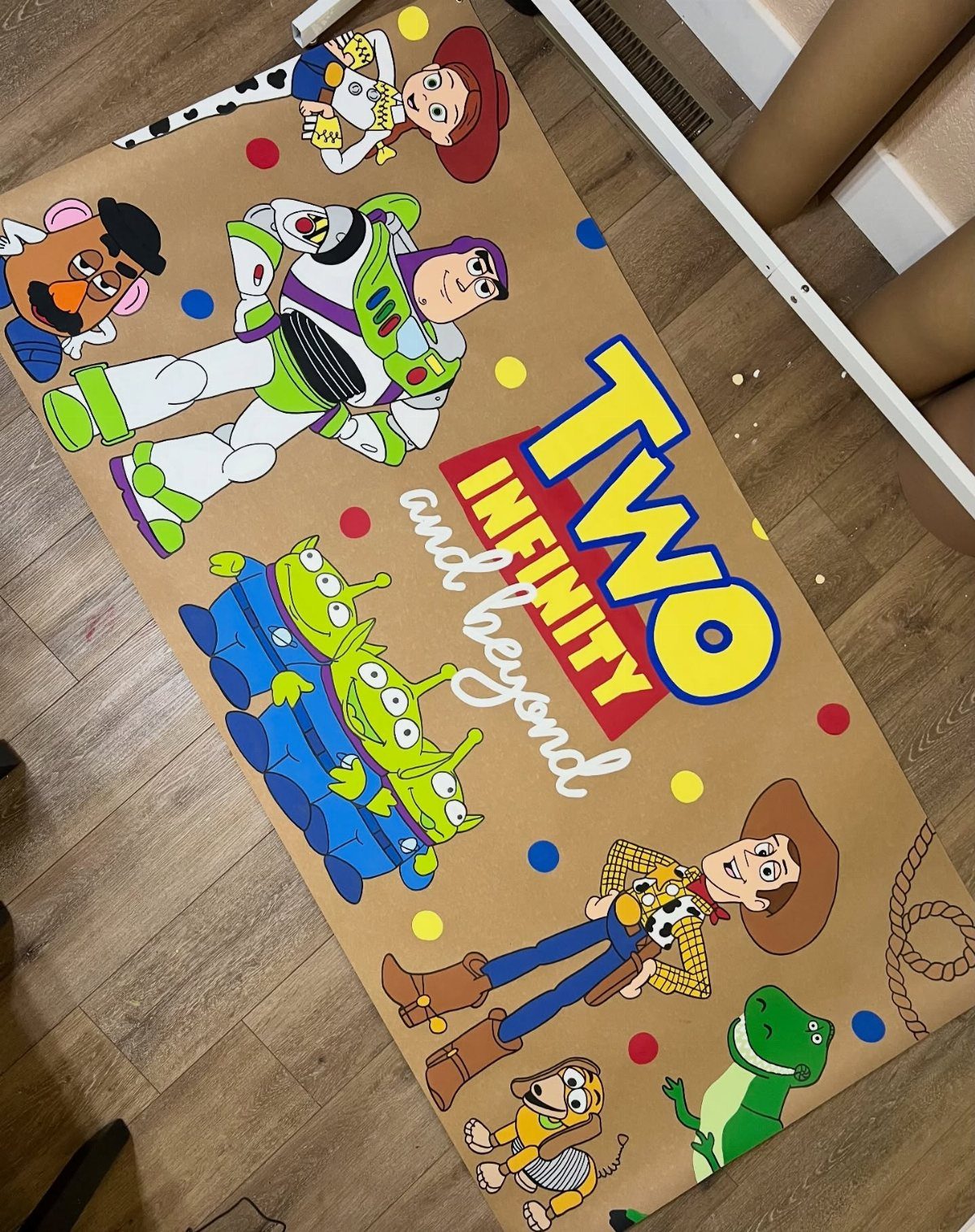 Toy Story themed birthday banner with characters and text on brown paper.