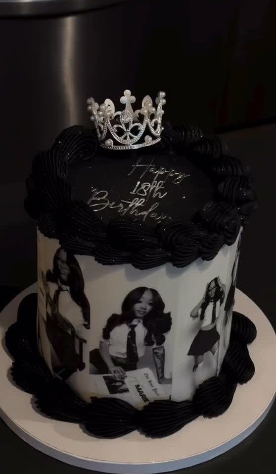 Black and white birthday cake with photos of a girl and a silver crown.
