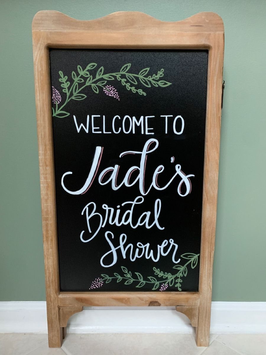 Chalkboard welcome sign for Jade's bridal shower in a rustic wooden frame.