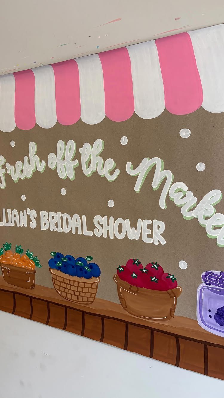 Hand-painted farmer's market themed bridal shower welcome sign with fruit baskets and awning