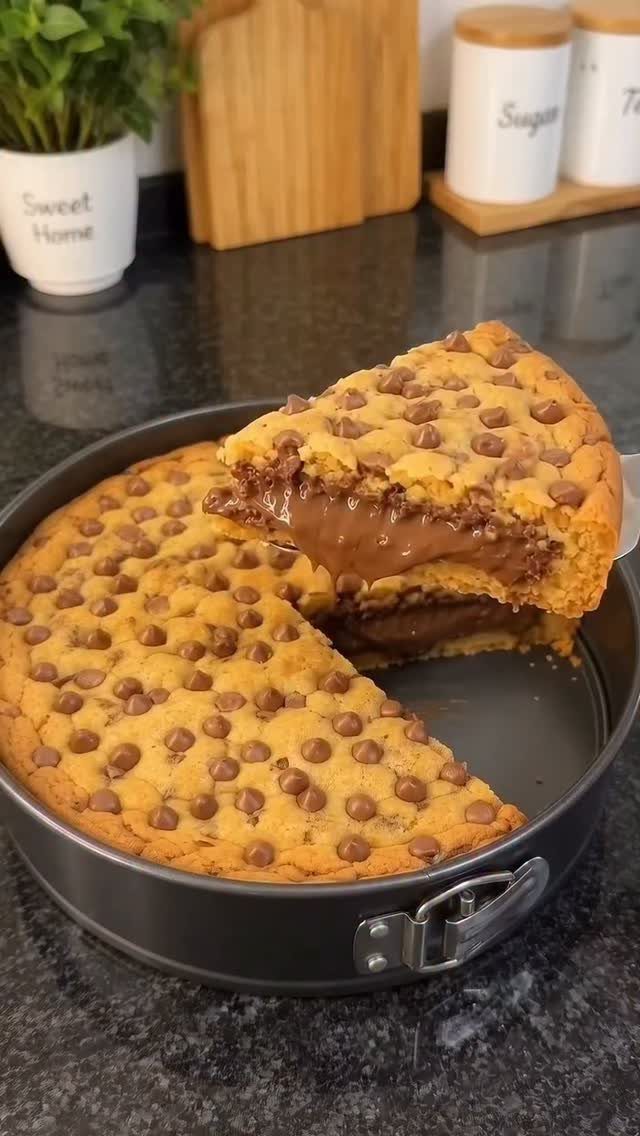 Chocolate chip cookie cake with melted chocolate filling in a springform pan