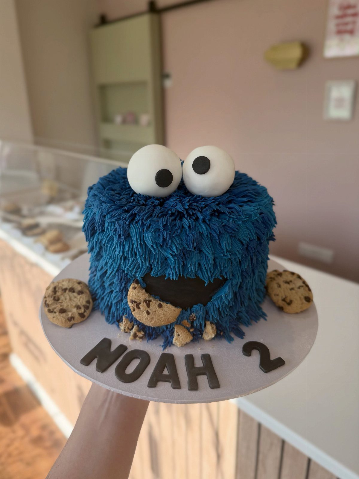 Blue shaggy monster cake with large eyes and chocolate chip cookies for Noah