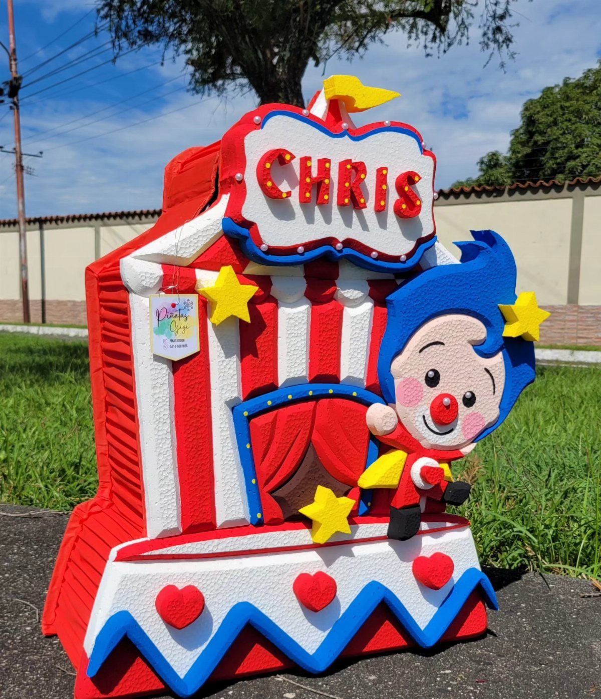 Clown and circus tent piñata with red and white stripes and name Chris.