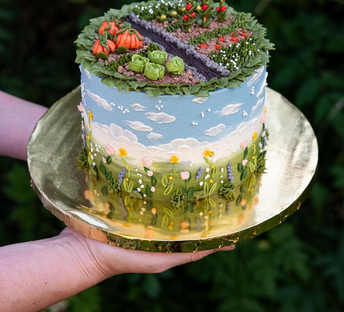 Cake decorated as a garden with candy pumpkins and a purple licorice path.