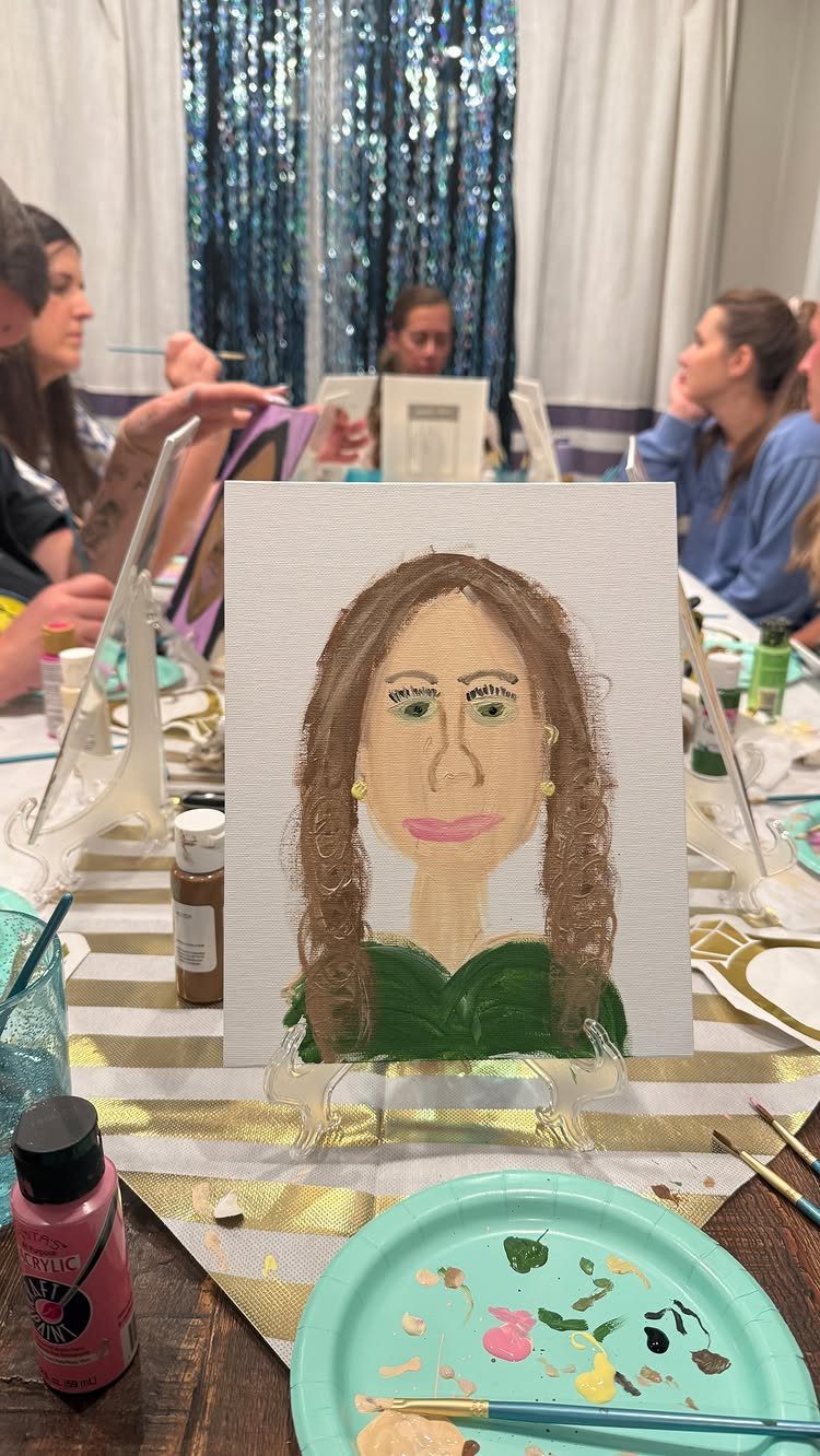 Painting party with women creating portraits on canvases at a decorated table
