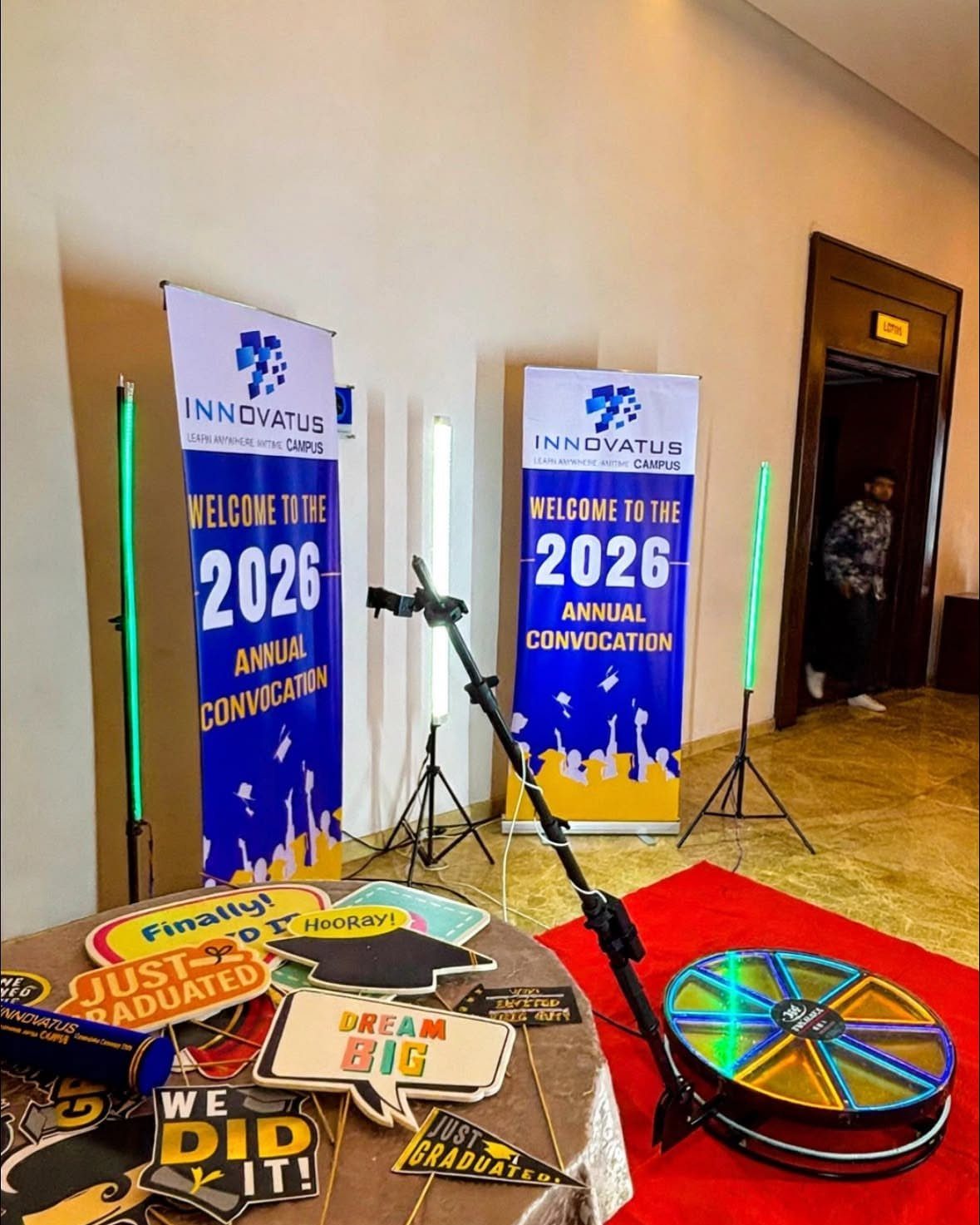 360 photo booth setup with rotating platform and graduation convocation banners