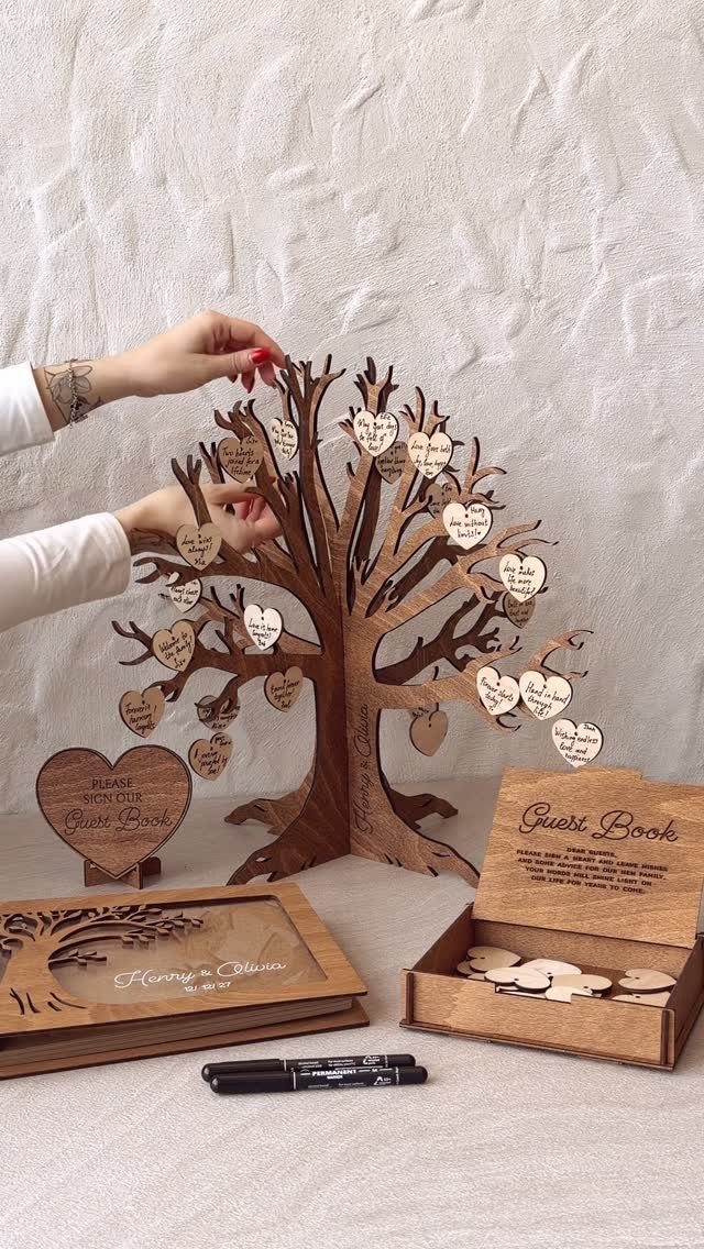 Wooden tree guest book with heart-shaped tokens and matching wooden accessories.