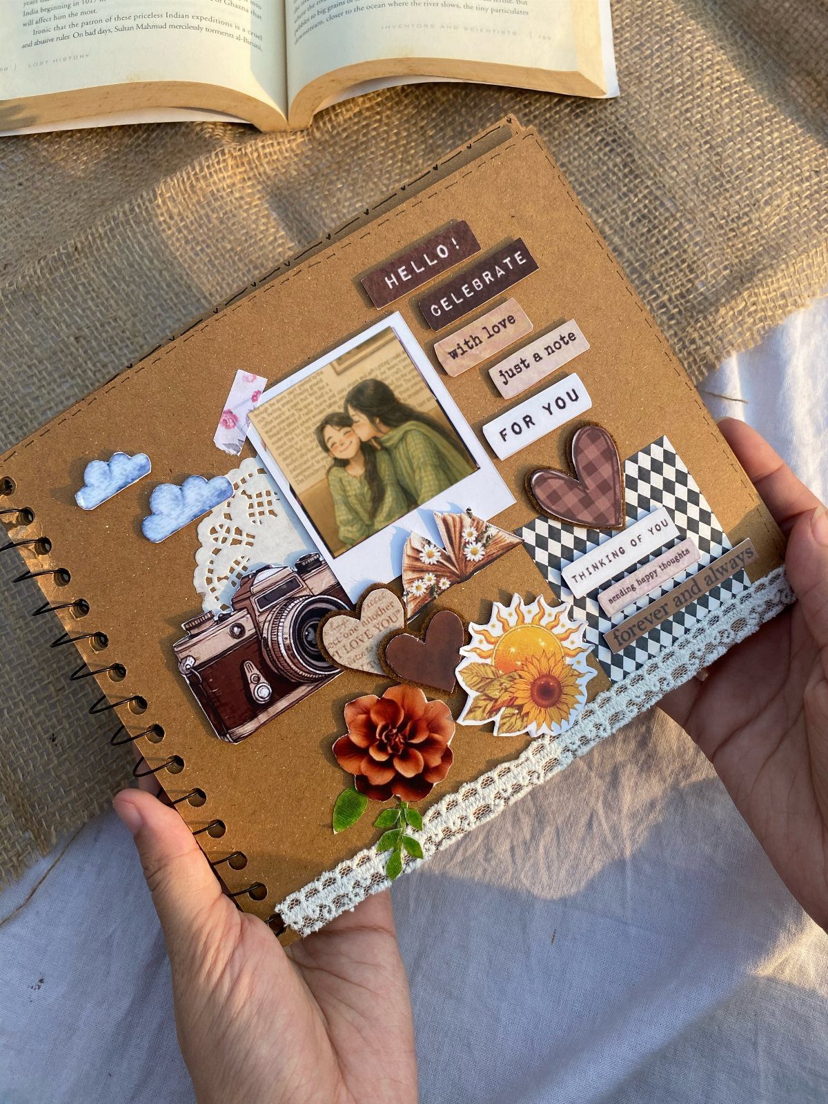 Scrapbook page with a couple's photo, floral stickers, and a vintage camera cutout.