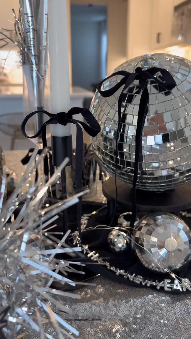 Disco balls and silver tinsel decorations with a Happy New Year banner.