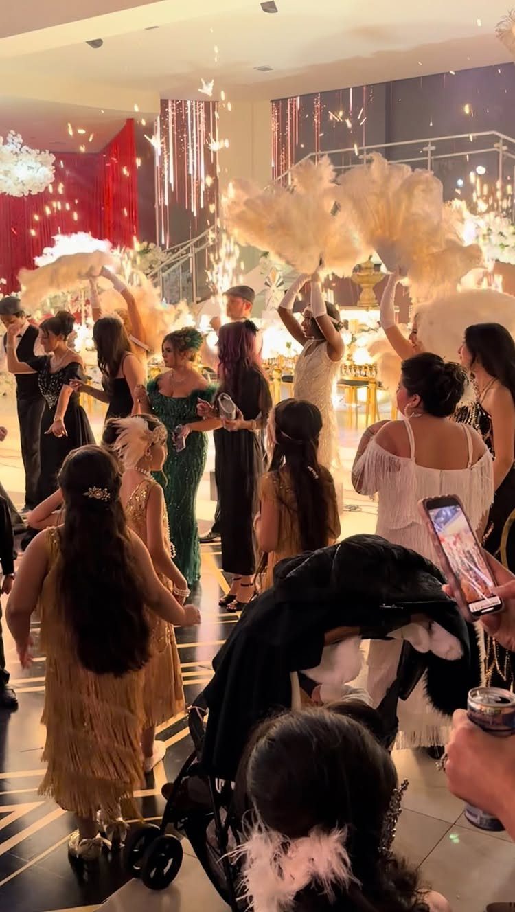 People in flapper dresses and feather headbands at a Roaring 20s Gatsby party.