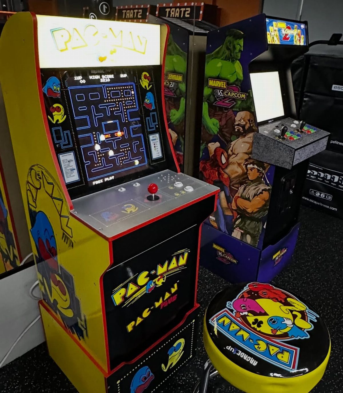 Arcade game machines including Pac-Man and Marvel vs. Capcom in a party setting