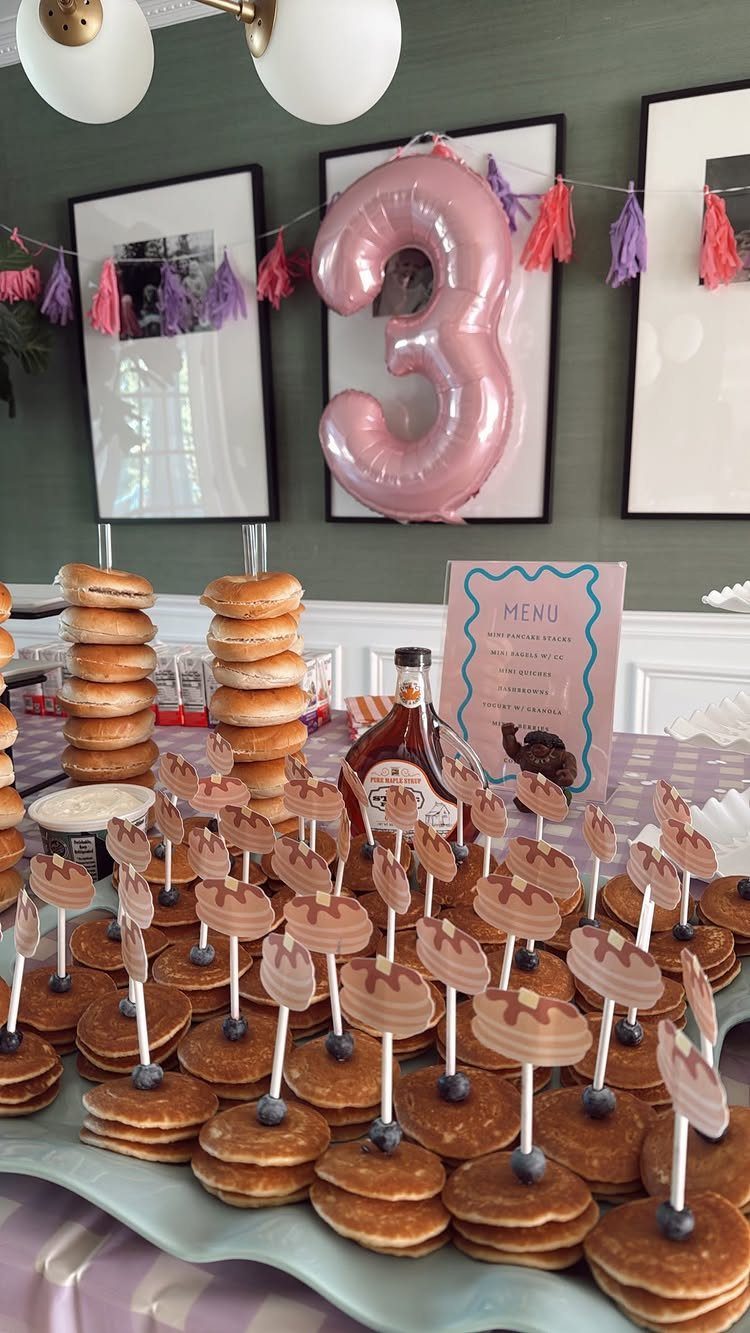 Mini pancakes with moose picks and donuts at a third birthday party celebration.