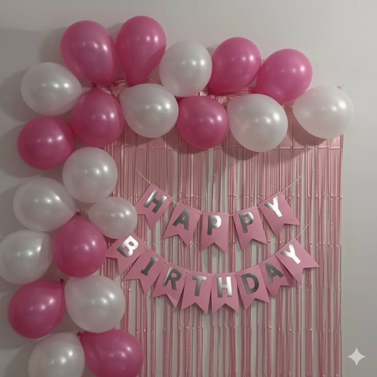 Pink and white balloons framing a pink foil curtain with Happy Birthday banner.