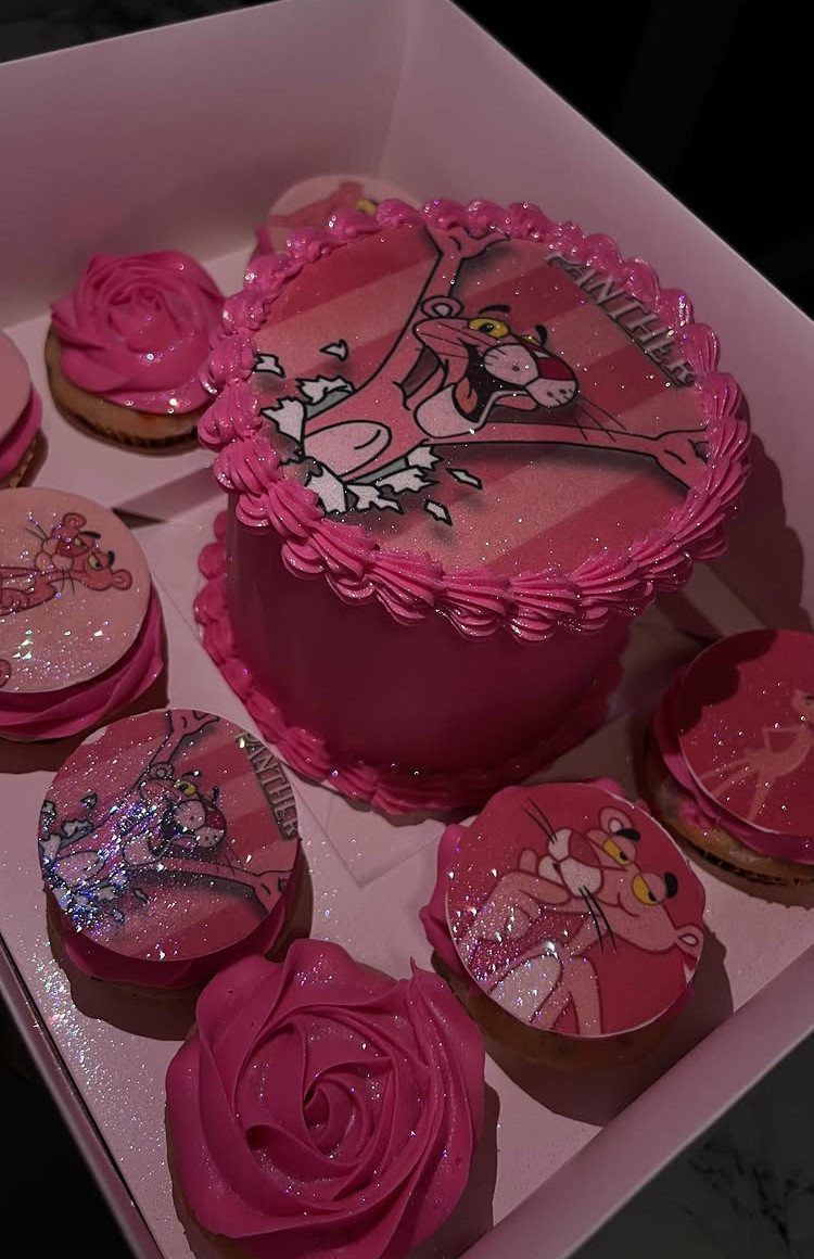 Pink cake and cookies featuring the Pink Panther character in a white box