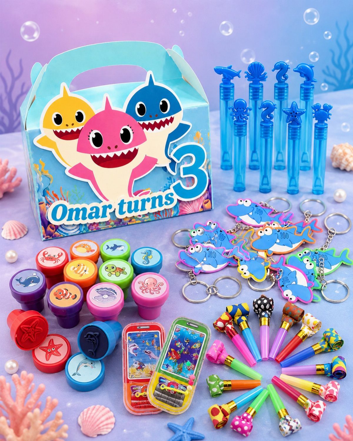 Shark themed party favors including a gift box, keychains, pens, and bubble wands.