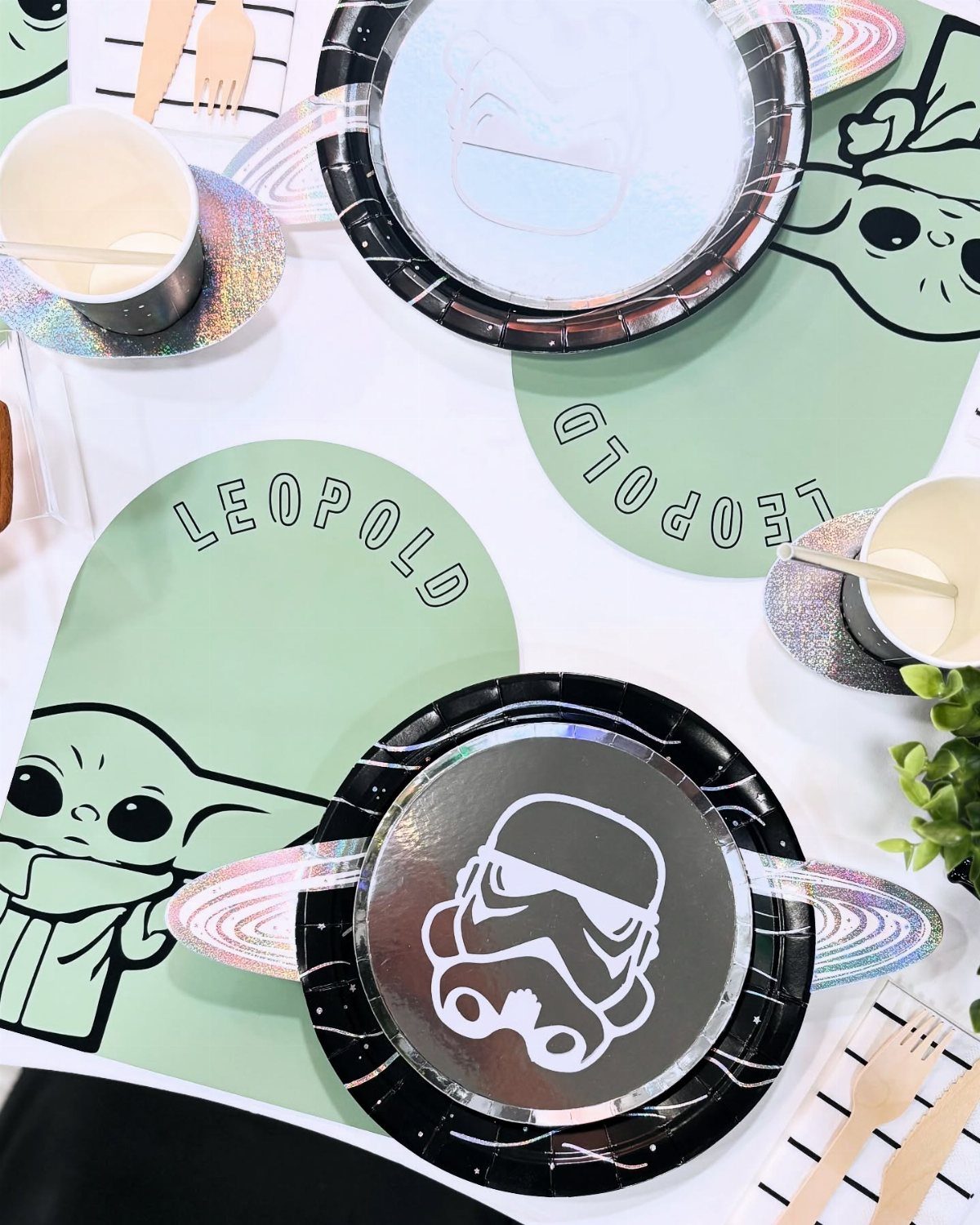 Star Wars themed table setting with Grogu placemats and Stormtrooper plates for a party.