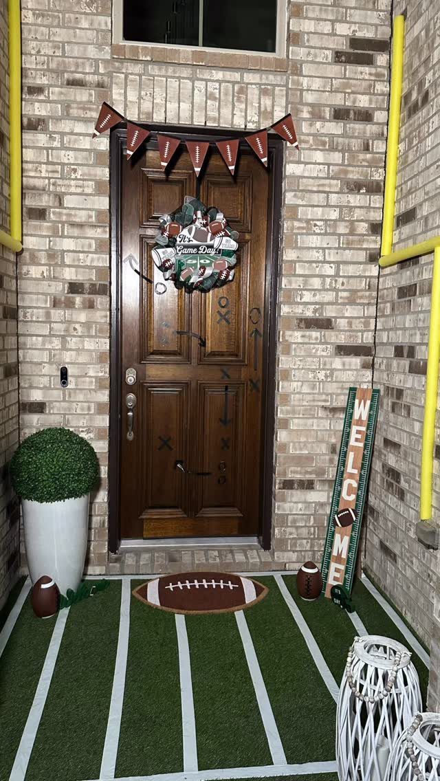 Football themed porch with green turf rug, football mat, and welcome sign.