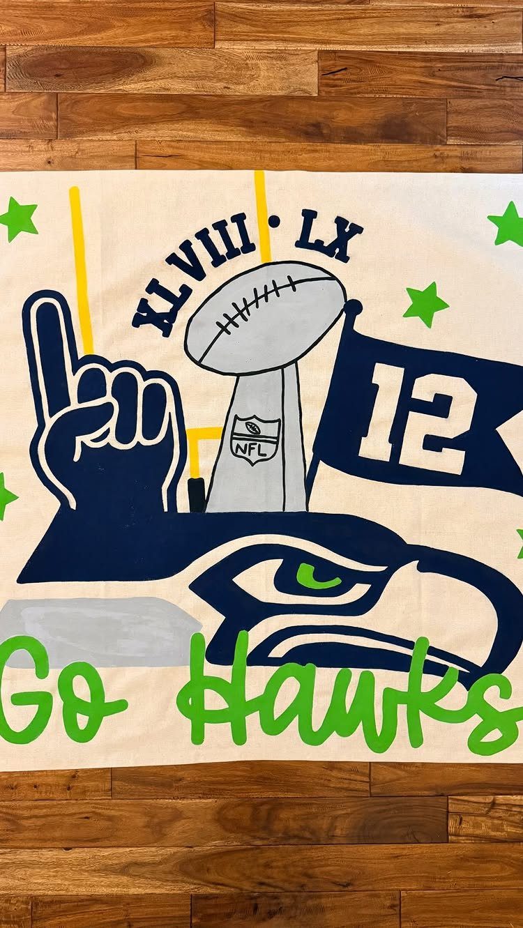 Seattle Seahawks themed fabric banner with football and Go Hawks text on wood.