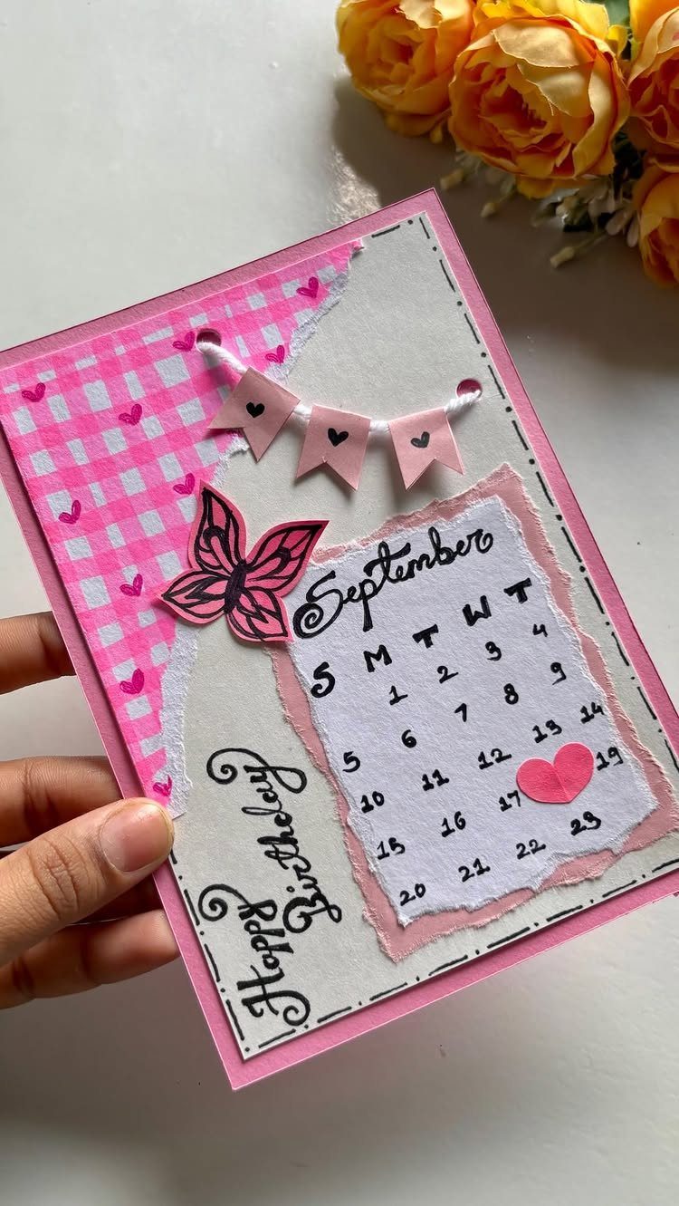 Handmade birthday card with a September calendar, pink butterfly, and small bunting banner.