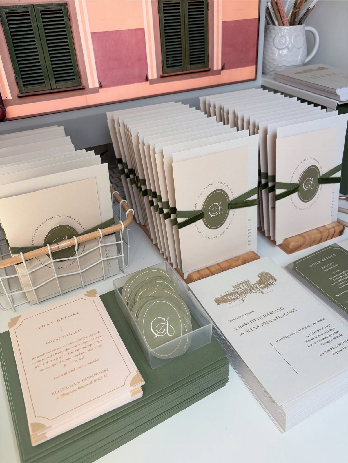 Wedding stationery set with cream and olive green invitations featuring a matching monogram.