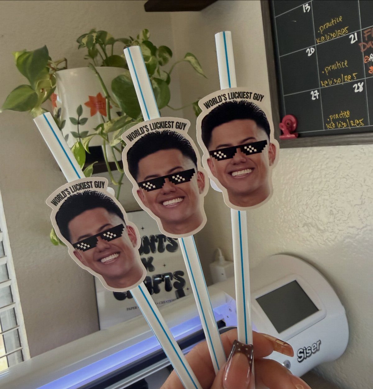 Custom straws with cutouts of a smiling man wearing sunglasses and text.