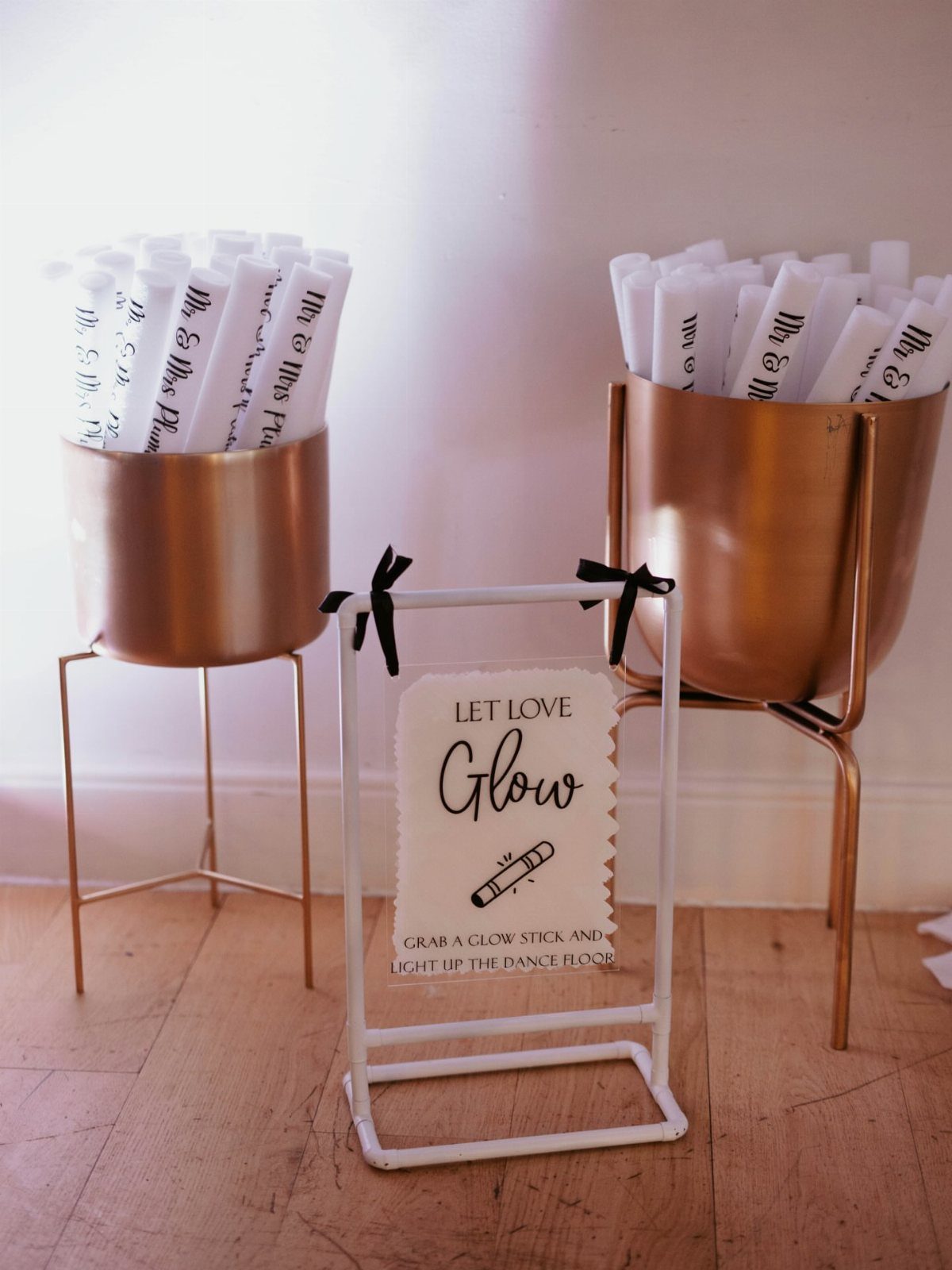Gold buckets filled with glow sticks and a Let Love Glow sign.