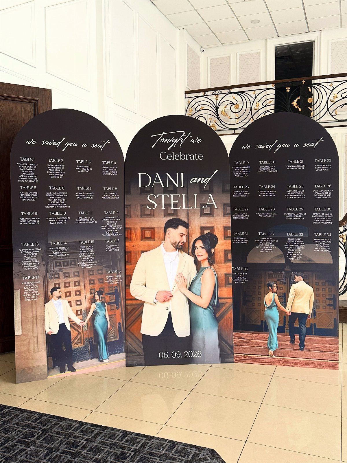 Three arched wedding seating charts featuring photos and names of the couple.